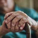 Elderly man holding a cane